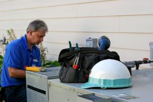 HVAC-technician-performing-AC-maintenance