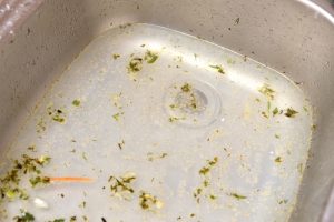 a-kitchen-sink-clogged-with-dirty-dishwater